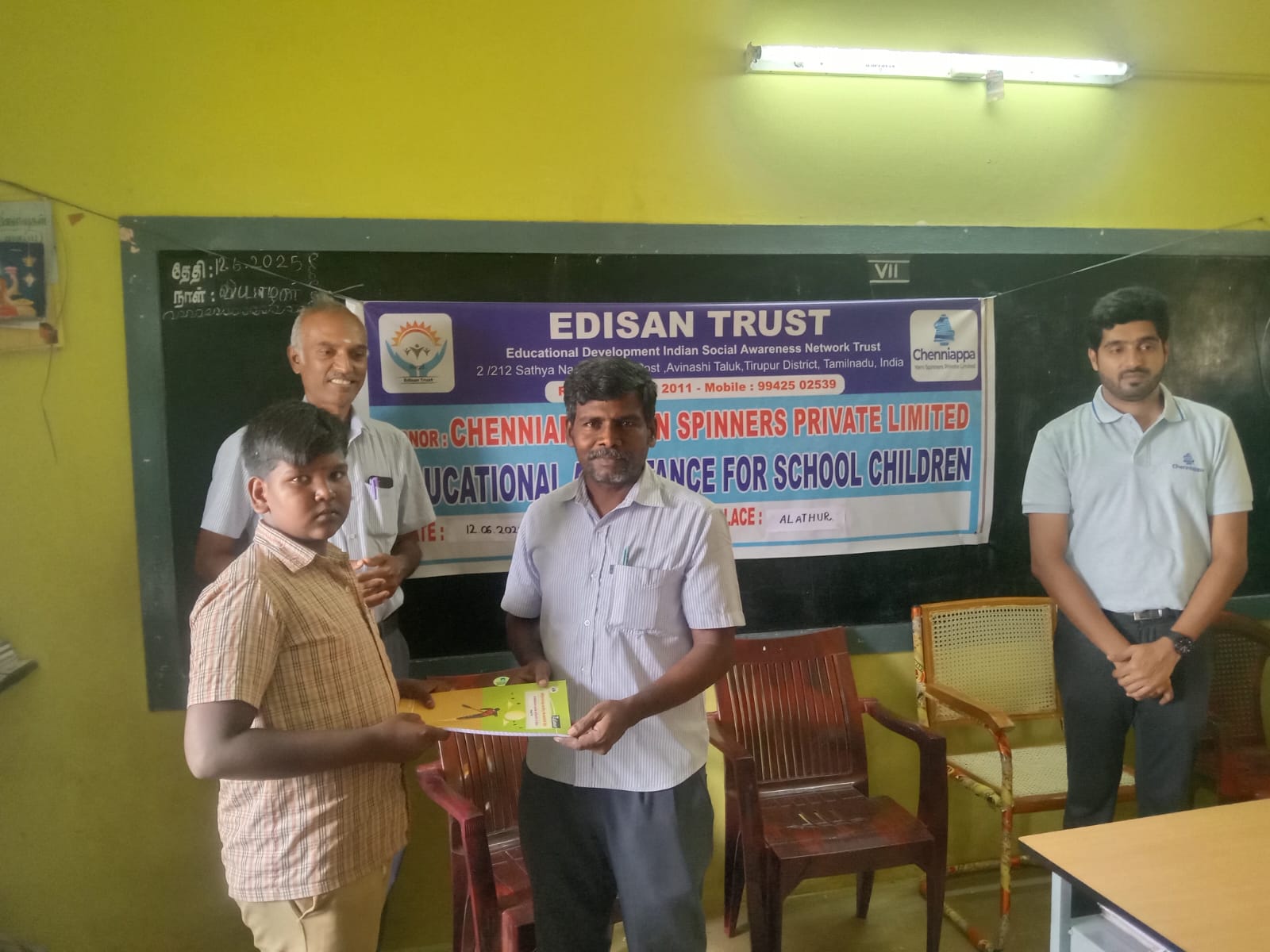 Classroom distribution of notebooks with Chenniappa Yarn Spinners representative